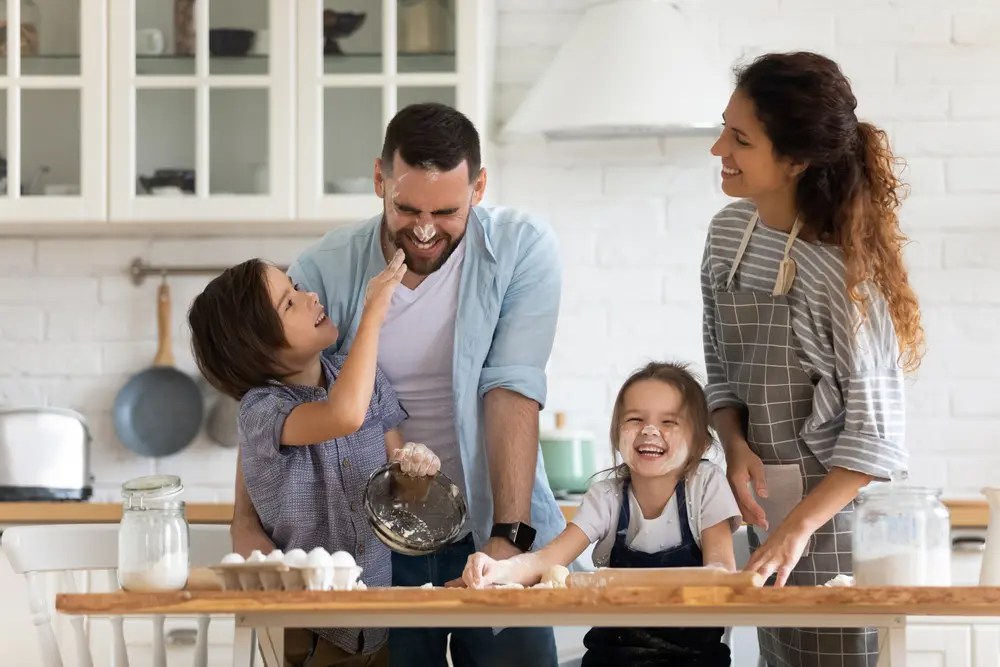 family playing while making food